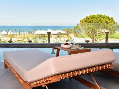 Pohodlné polstrované lehátko na terase s výhledem na moře a pláž