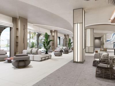 Jasna, nowoczesna przestrzeń wypoczynkowa hotelu z sofami, pufami i dużymi oknami.