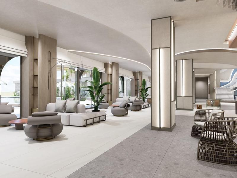 Jasna, nowoczesna przestrzeń wypoczynkowa hotelu z sofami, pufami i dużymi oknami.