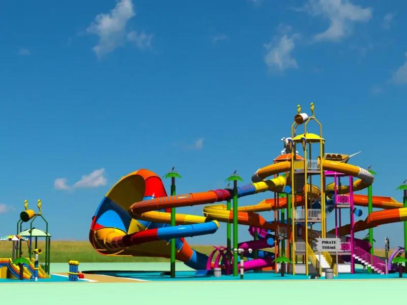 Kolorowy park zjeżdżalni wodnych pod jasnym niebieskim niebem i zieloną trawą w tle.