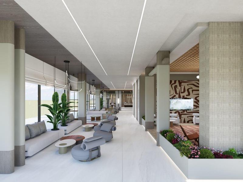 Nowoczesna przestrzeń wypoczynkowa hotelu z miejscami do siedzenia, roślinami i naturalnym światłem.