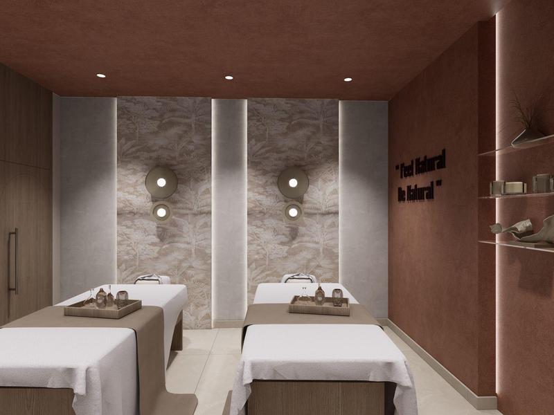 Nowoczesny pokój spa z dwoma stołami do masażu i uspokajającym, minimalistycznym wystrojem.