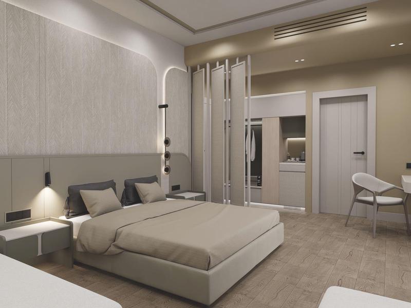 Nowoczesny pokój hotelowy z dużym łóżkiem, wygodnymi krzesłami i minimalistycznym wystrojem.