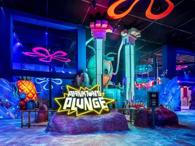 Kleurrijke binnen waterparkdecoratie met neonlichten en thematisch ontwerp.