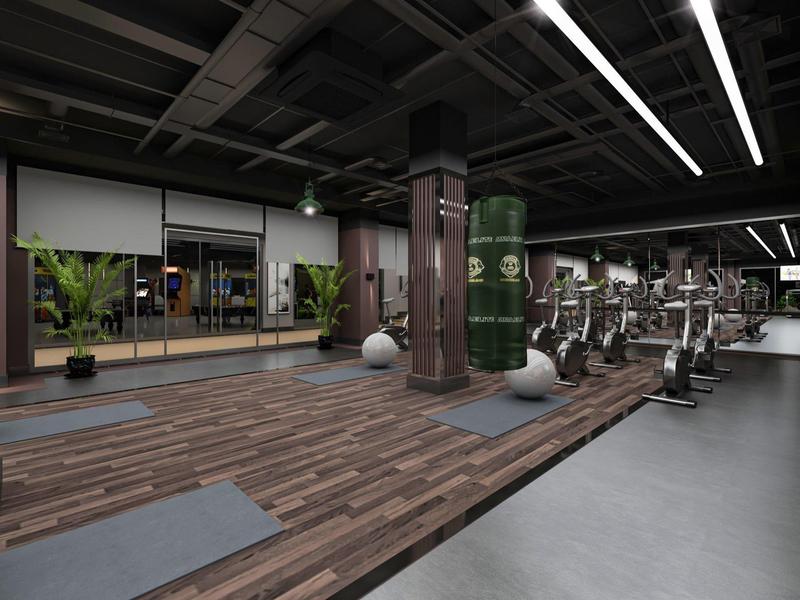 Palestra moderna con pavimento in legno, tappetini, sacco da boxe e attrezzature fitness.