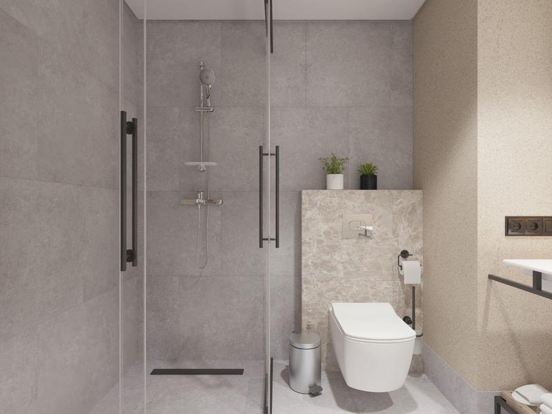 Area doccia moderna con parete in vetro e WC in un bagno elegante.