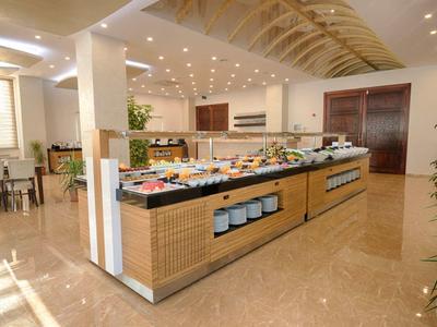 Modern buffet in bright restaurant with marble flooring and stylish wood details.