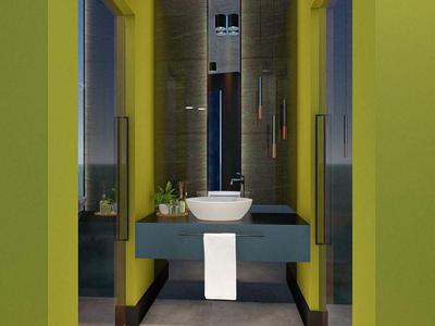 Moderne hotelgang met groene muren, grijze vloer en eigentijdse wasbak.