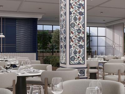 Interno moderno di ristorante di hotel con tavoli e sedie eleganti, design decorativo della colonna, molta luce naturale.