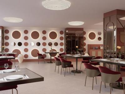 Moderner Speisesaal mit runden Tischen, Stühlen und einer dekorativen Wand mit Kreismustern.