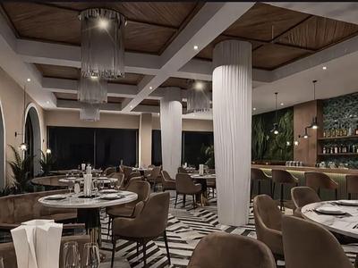 Ristorante elegante dell'hotel con sedie imbottite scure, tavoli rotondi e illuminazione di design.