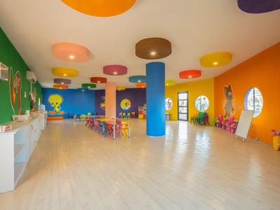 Barevná herna s dětským nábytkem a vícebarevnými zdmi v hotelu.