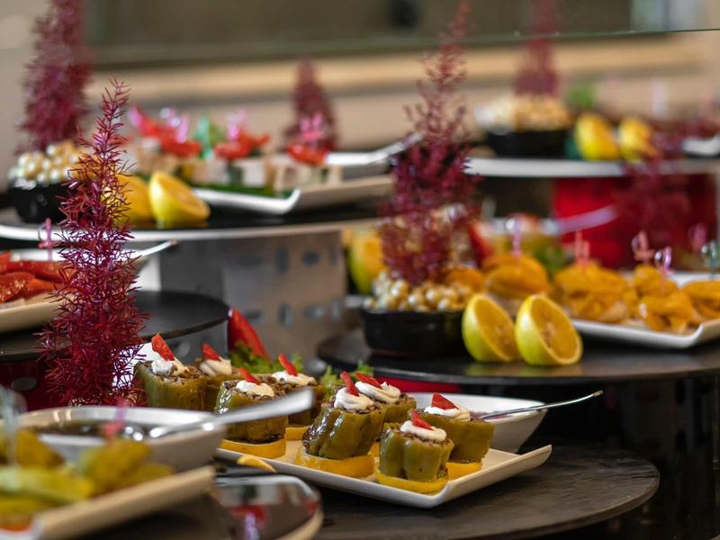 Plates with assorted appetizers and garnishes arranged on a table.