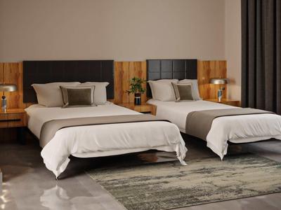 Habitación de hotel moderna con dos camas individuales, paredes grises y suelo alfombrado.