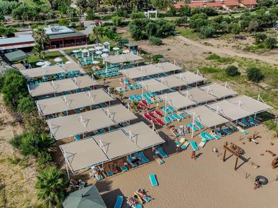 Aerial view of a large hotel complex with multiple buildings, pool, and surrounding landscape.