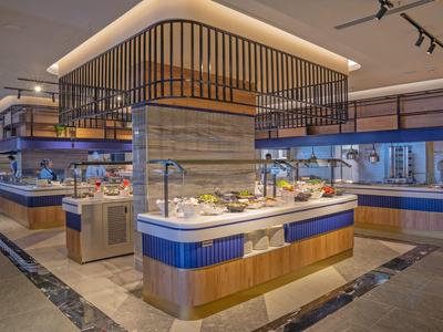 Modern hotel buffet with a variety of dishes in an elegant dining area.