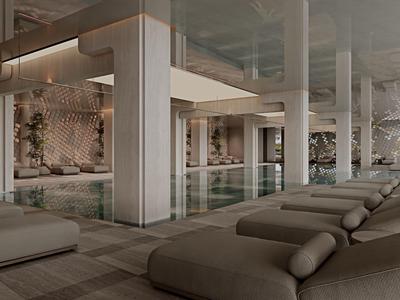 Modern hotel indoor pool area with large columns and padded loungers in neutral tones.