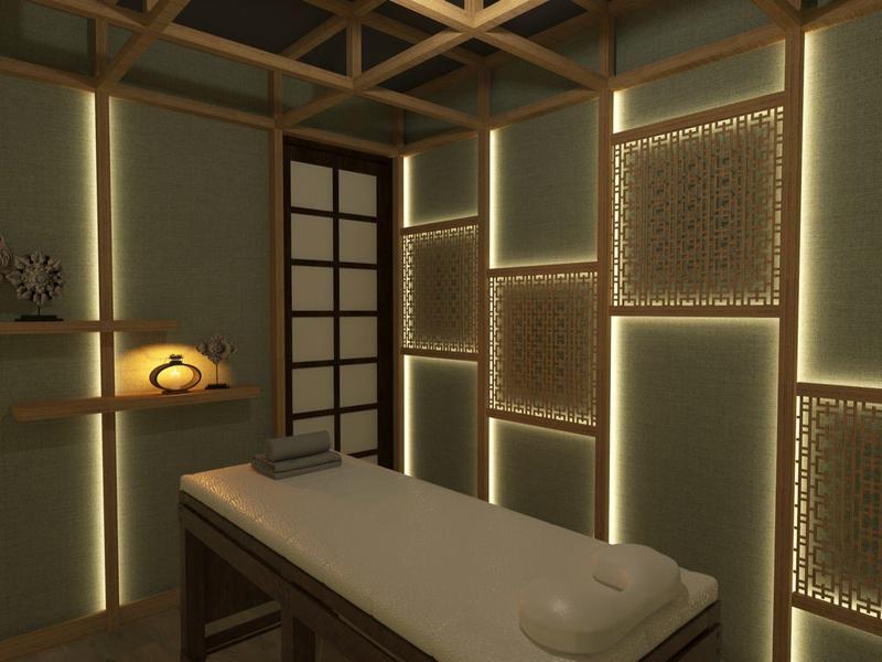 Salle de massage confortable avec éclairage tamisé et table avec serviette.