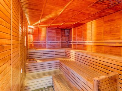 Sauna room with wooden benches and warm lighting