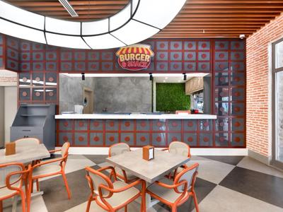 Modernly designed snack area with tables and seating indoors.