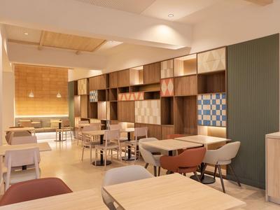 Modern dining area with wooden furniture, upholstered chairs, and warm lighting.