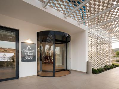 Hotel entrance with glass revolving door and decorative lattice roof