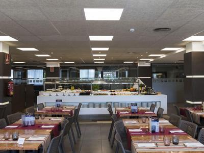 Modern restaurant with set tables and buffet in the background