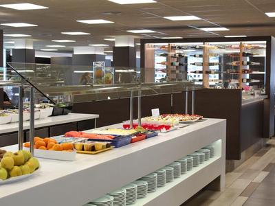 Buffet area with various foods on white counter in modern restaurant