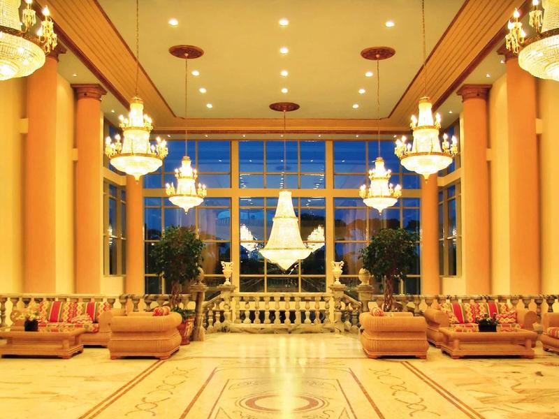 Luxurious hotel lobby with elegant chandeliers and comfortable seating.