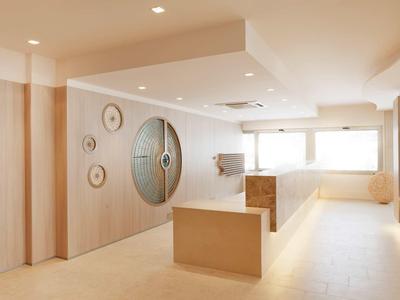 Moderner, heller Raum mit Holzvertäfelungen, runden Wanddekorationen und großen Fenstern.