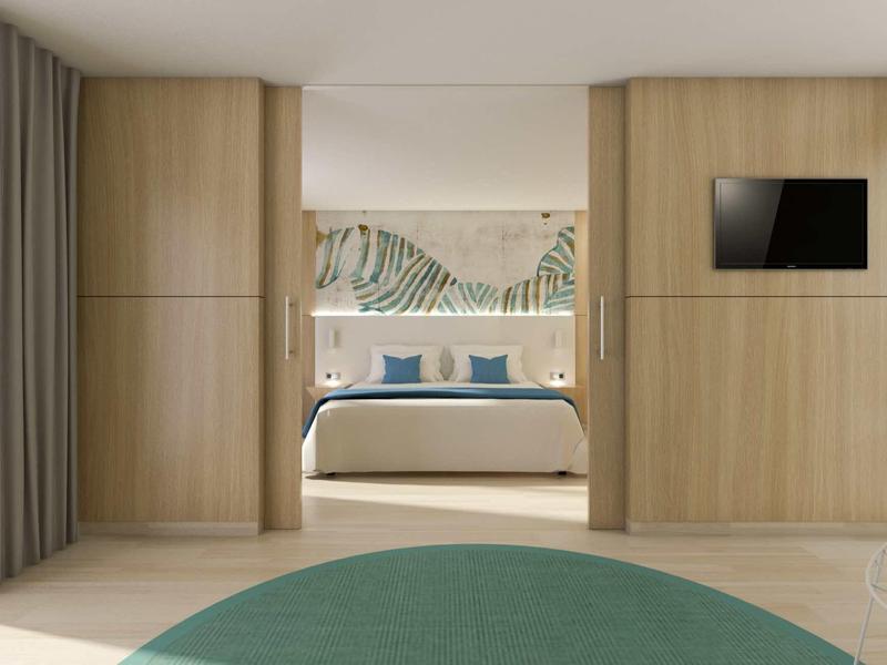 Camera d'hotel moderna con letto matrimoniale, TV a parete e rivestimenti in legno eleganti.