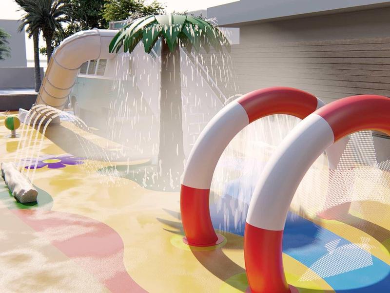 Area giochi acquatica per bambini con scivoli, getti d'acqua e archi colorati all'aperto.