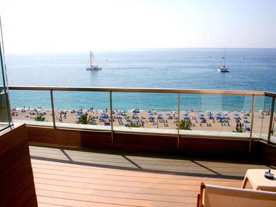 Balcony with sea view and two sailboats on a sunny beach