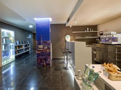 Lounge di hotel moderna con snack, distributore di bevande fredde e bancone con sgabelli