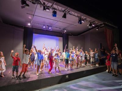 Großer Hotelpool mit mehreren Becken und Sonnenliegen, im Hintergrund Bäume und blauer Himmel.