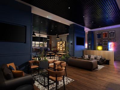 Eleganter Hotel-Loungebereich mit Sitzgarnitur, Teppich und stimmungsvoller Beleuchtung.
