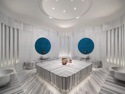 Moderner Wellnessbereich mit Marmor, runden Fenstern und indirekter Beleuchtung.