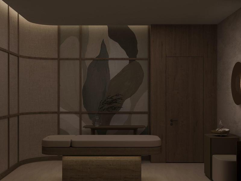 Sfeervolle wellnessruimte met massagetafel, zachte verlichting en abstracte wanddecoratie.