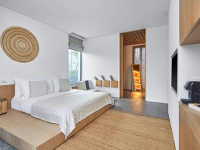 Modern bedroom with large platform bed and window view