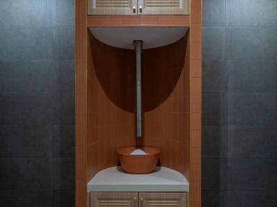 Armoire en bois moderne avec distributeur d'eau intégré dans une pièce sombre.