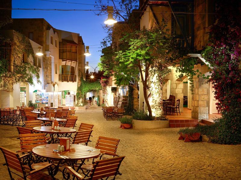 Cozy outdoor dining area on a cobblestone square at evening light