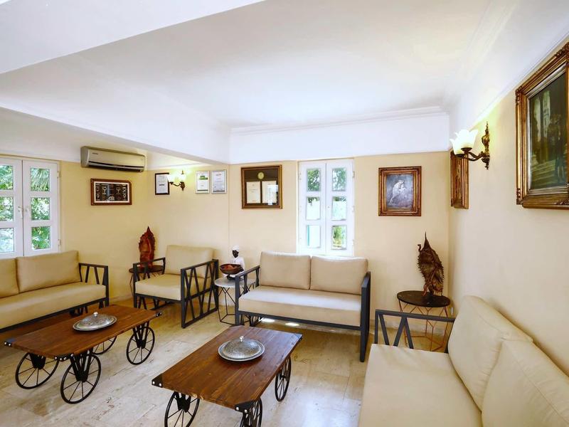 Bright living area with comfortable sofas, wall art, and small tables.