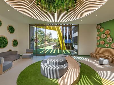 Modern light green hotel lounge area with wood details and view of children's playground.