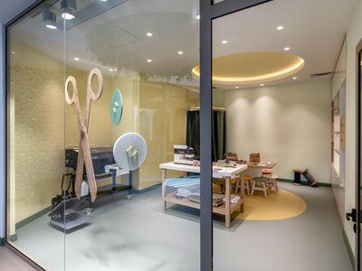 Modern, bright meeting room with large scissors decoration behind glass.