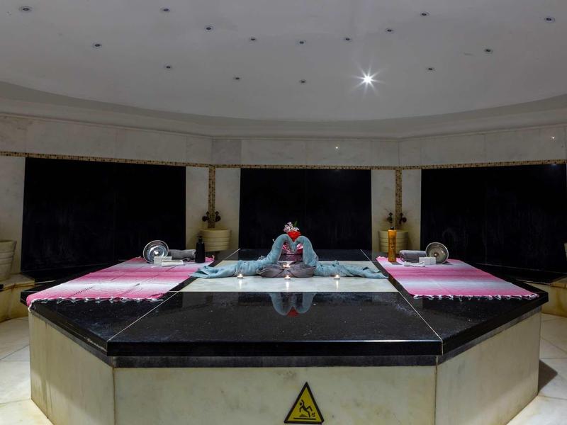 Elegant spa area with central water basin and relaxing lighting.