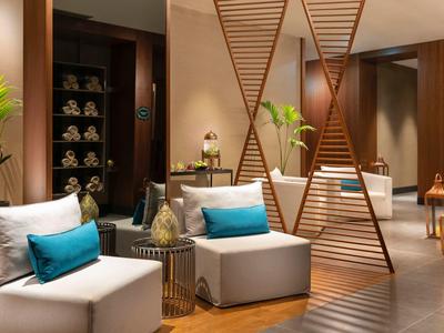 Modern hotel lounge area with comfortable seating and decorative accents.