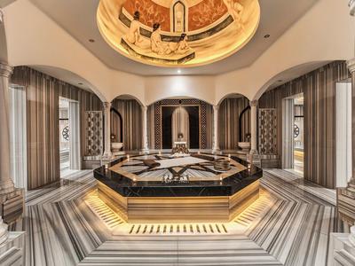 Elegant spa area with central water pool, marble tiles, and artistic ceiling painting.