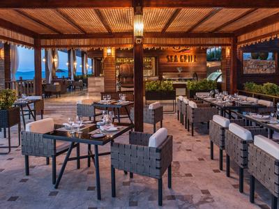 Inviting outdoor restaurant area with set tables and modern decor at dusk.