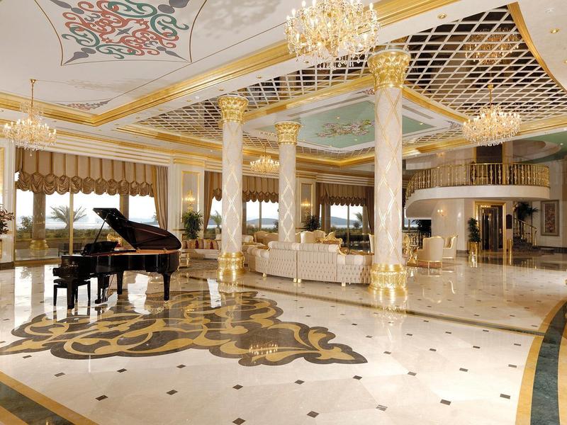 Large, elegant hotel lobby with piano, chandelier, and classic decor