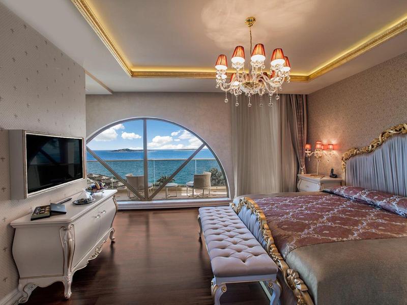 Luxurious bedroom with large window and sea view